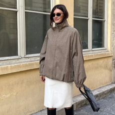 woman wearing fall boots with skirt outfit 2025