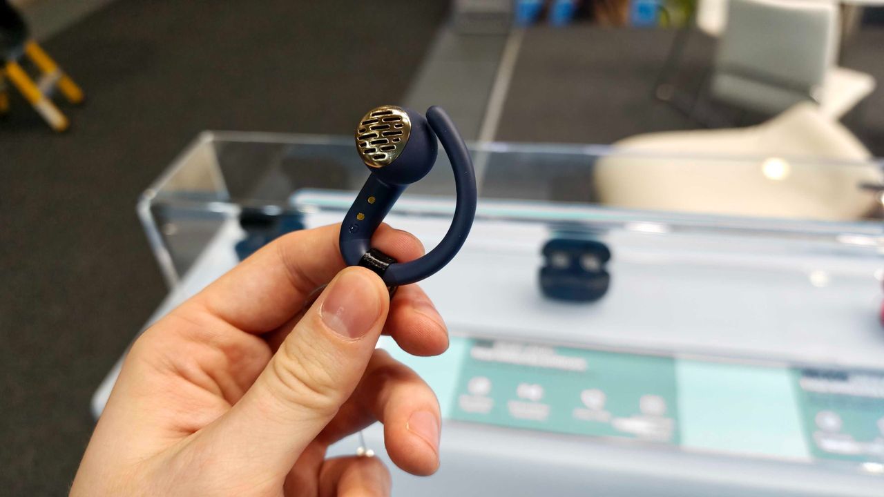 JLab's new earbuds at IFA, on a blue table