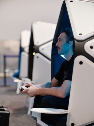 someone playing a game in a pod