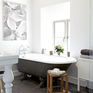 bathroom with white wall and bathtub