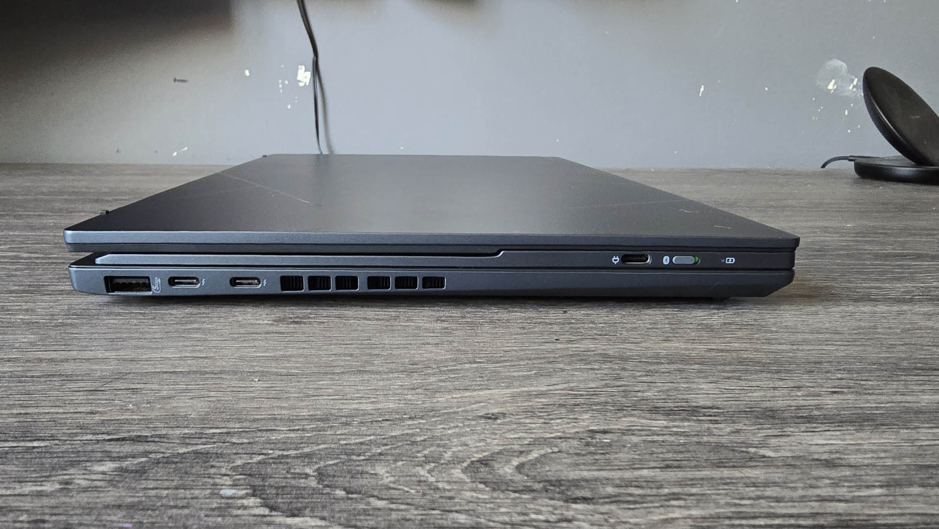 The Asus Zenbook Duo laptop photographed on a wooden desk.