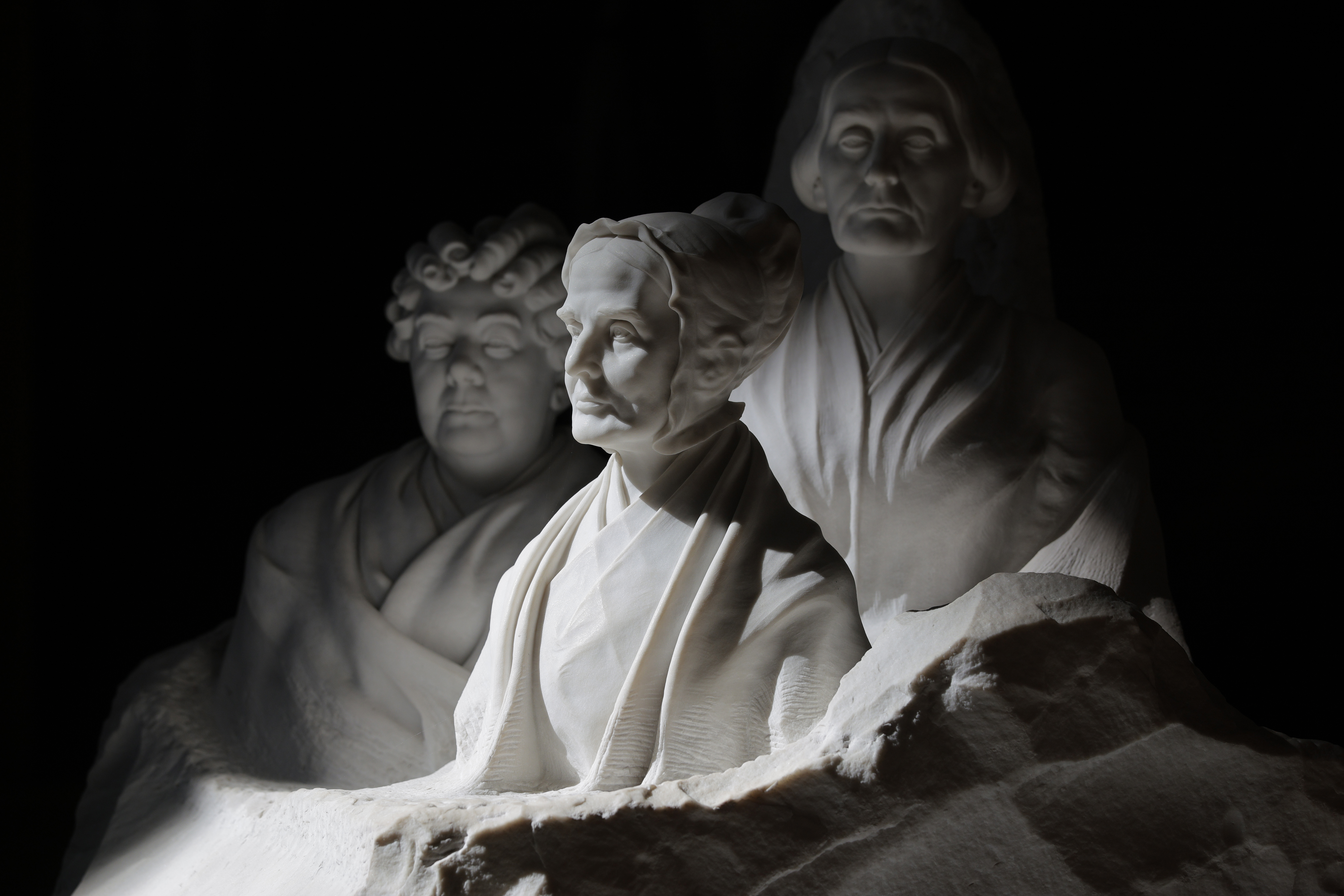 Sunlight hits a sculpture of Elizabeth Cady Stanton, Susan B. Anthony and Lucretia Mott inside the U.S. Capitol