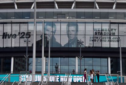 wembley stadium with oasis poster