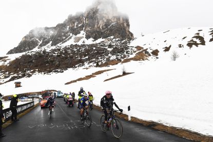 Hugh Carthy, João Almeida and Giulio Ciccone battling up the snow covered Passo Giau on stage 16 of the Giro d'Italia 2021