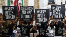 Protestors hold up signs that read 'Without justice, there is no future!' in the Congress of Mexico City earlier this month