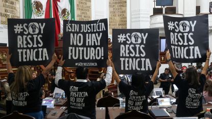 Protestors hold up signs that read &#039;Without justice, there is no future!&#039; and &#039;I am the resistance&#039; in the Congress of Mexico City earlier this month