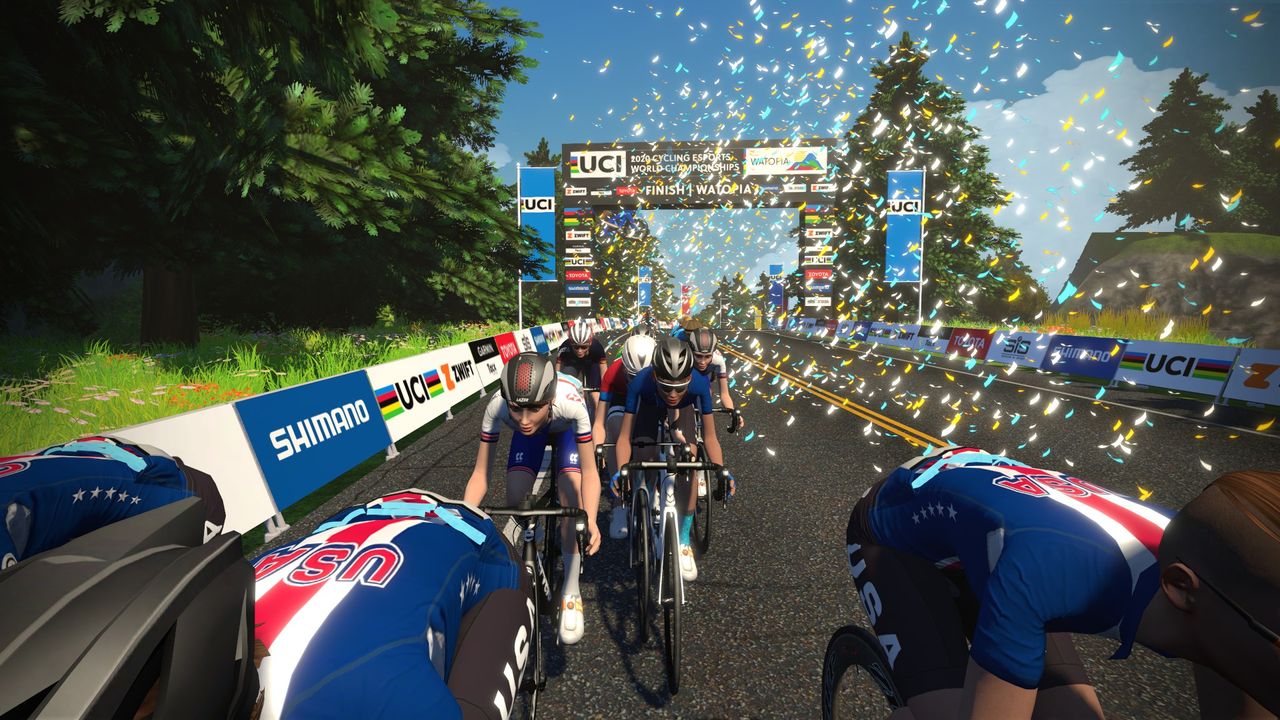 The women's peloton go through the finish area