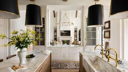 A double island kitchen with a hatch into the living room