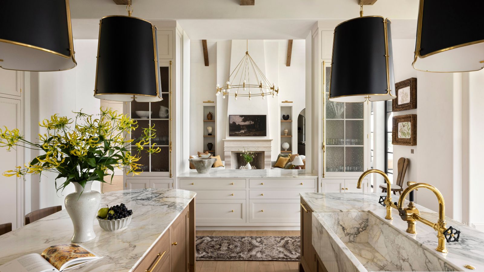 A double island kitchen with a hatch into the living room