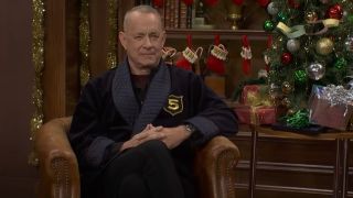 Tom Hanks sitting in his Five-Timers Club robe during a Five-Timers Club sketch on Saturday Night Live.