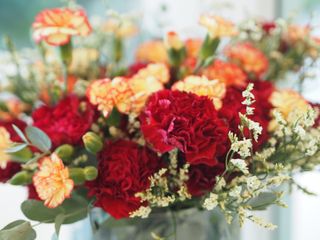A bouquet of red, yellow, and orange carnations.