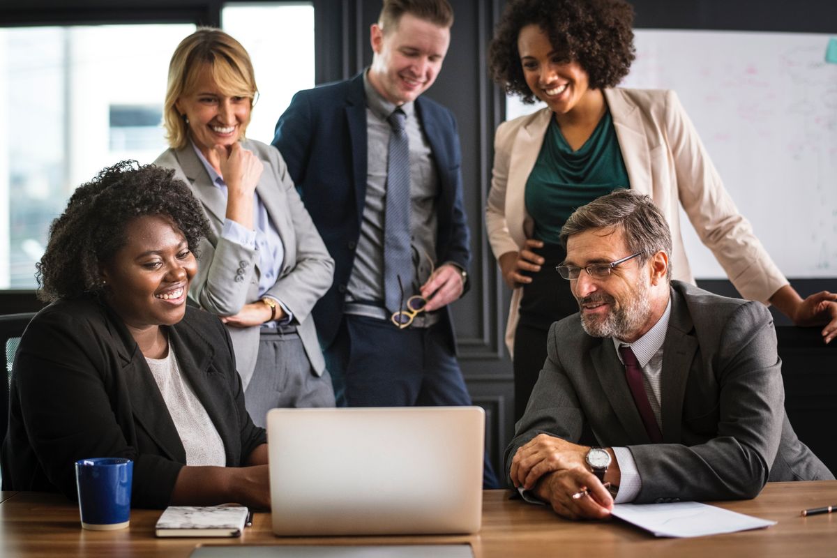 Business people around a computer.