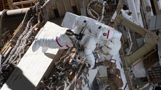 NASA astronaut Anne McClain, wearing a size medium spacesuit, works outside the International Space Station during a spacewalk on March 22. 