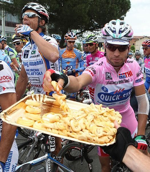 Riders are treated to some local baked goods at the start of stage 12.