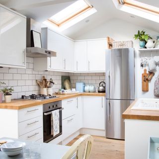 small kitchen with stainless steel fridge freezer
