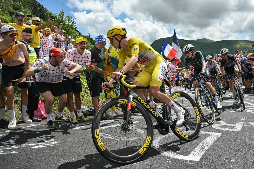 UAE Team Emirates team's Slovenian rider Tadej Pogacar wearing the overall leader's yellow jersey (C) cycles ahead of Team Visma - Lease a Bike team's Danish rider Jonas Vingegaard (2nd L), Red Bull - BORA - hansgrohe team's Slovenian rider Primoz Roglic and Soudal Quick-Step team's Belgian rider Remco Evenepoel wearing the best young rider's white jersey (rear) in the ascent of Pas de Peyrol (Puy Mary) during the 11th stage of the 111th edition of the Tour de France cycling race, 211 km between &Atilde;vaux-les-Bains and Le Lioran, in the Massif Central mountains of central France, on July 10, 2024. (Photo by Marco BERTORELLO / AFP)