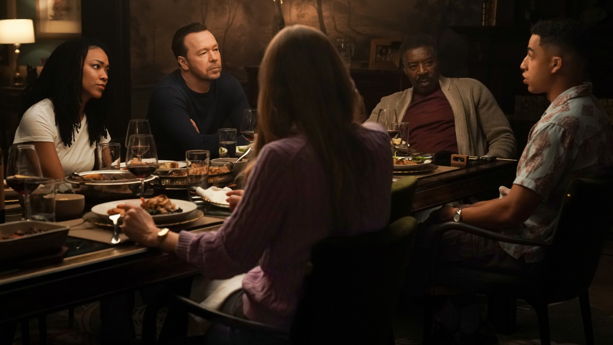 Lena, Danny, Reverend Peters, Jonah, and Sarah gathering for family dinner on Boston Blue.