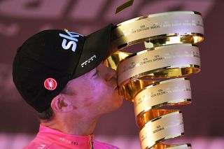 Team Sky's Chris Froome gets his hands - and lips - on the trophy as winner of the 2018 Giro d'Italia