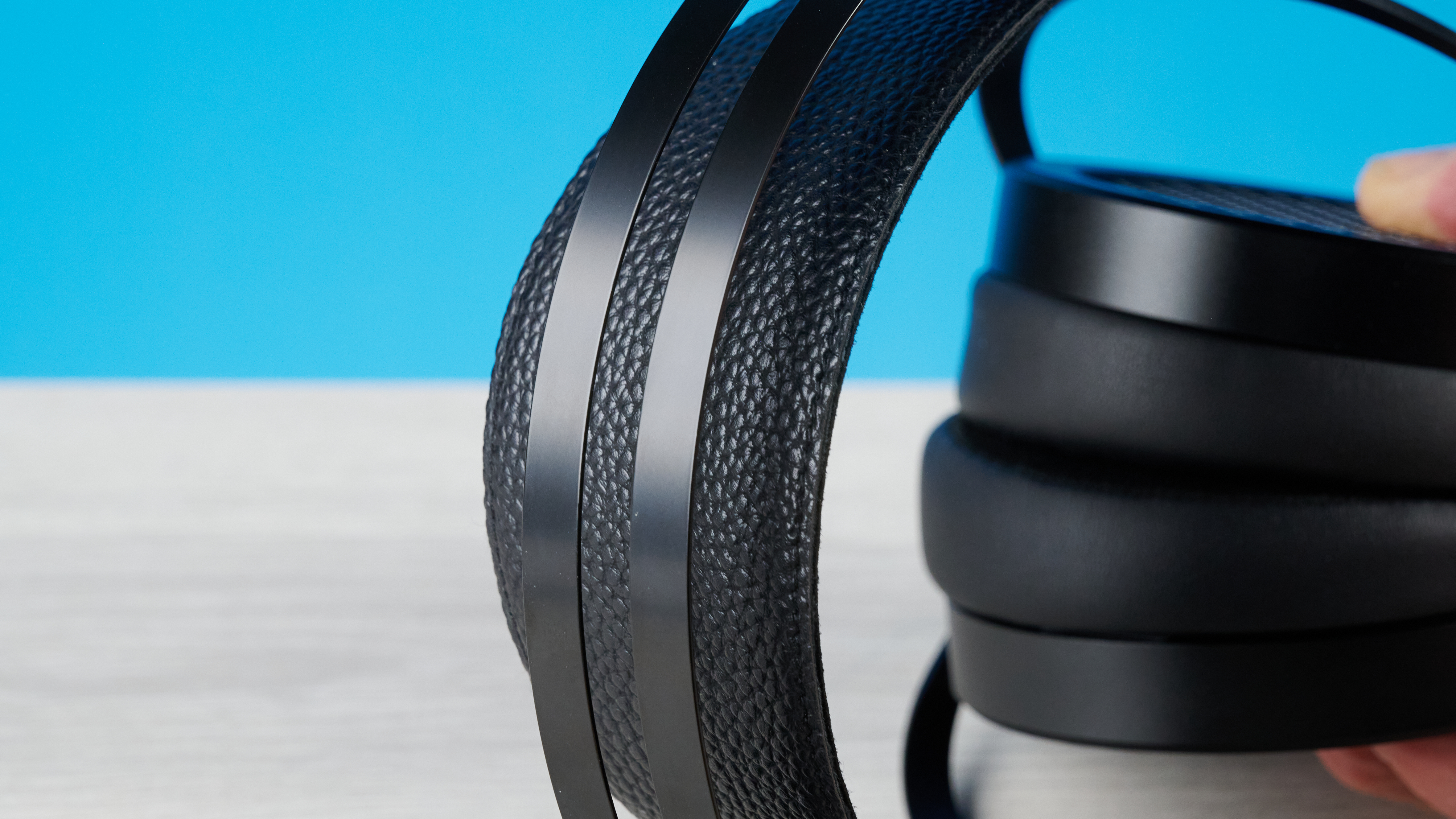the HIFIMAN Sundara open-back wired audiophile headphones photographed against the blue toms' guide background