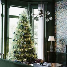 christmas tree in dark green living room