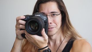 Reviewer James Artaius holds the Canon EOS R3