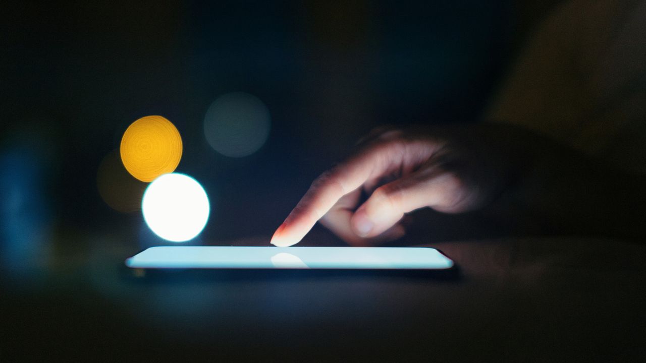 Woman&#039;s hand on cell phone