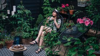 Woman sitting in her garden