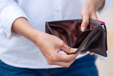 Woman opening an empty wallet