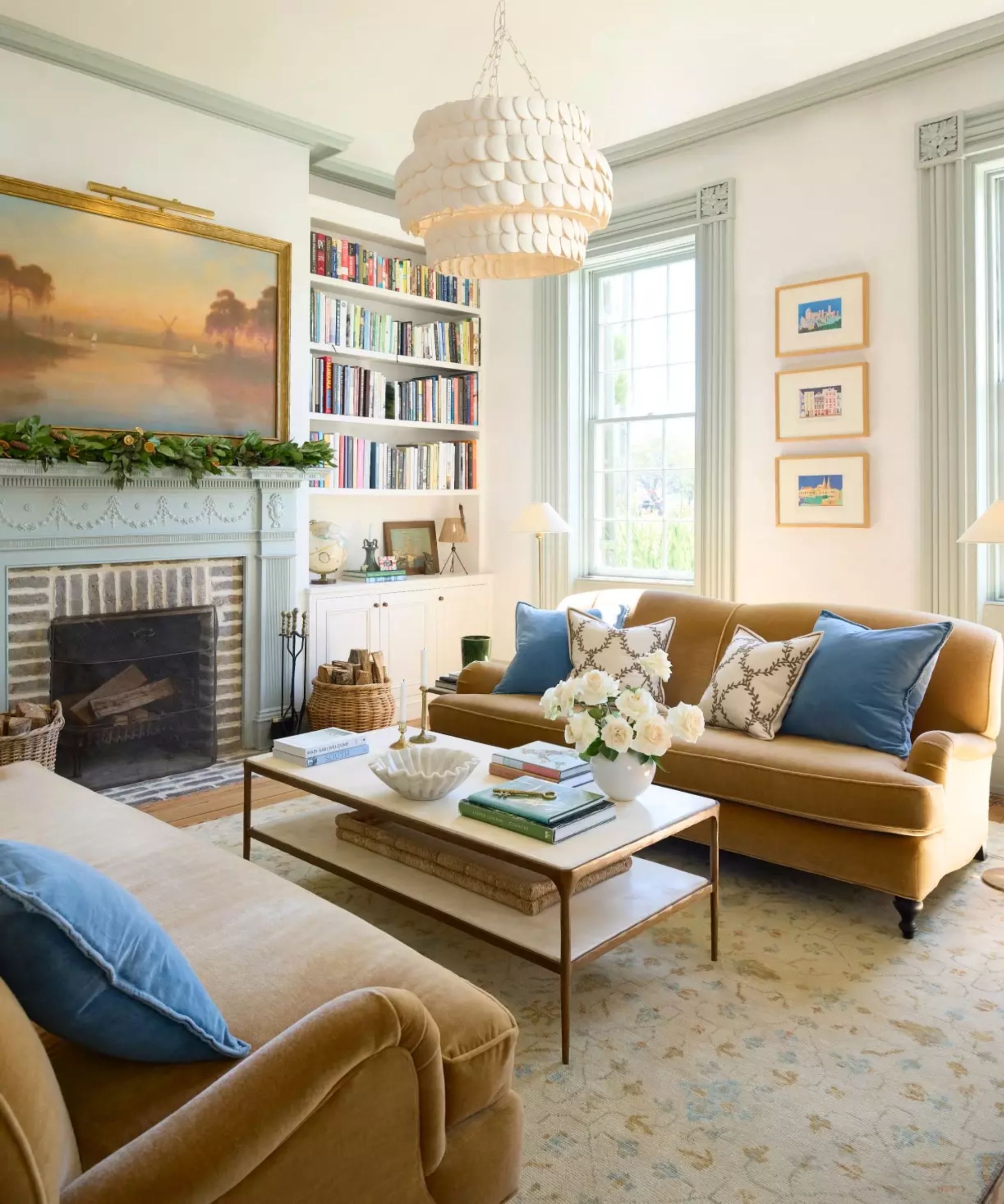 coastal living room with pale blue fireplace and camel velvet couches