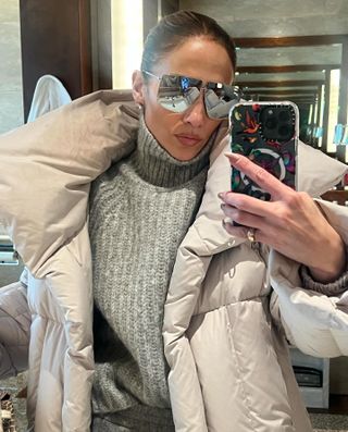 Jennifer Lopez wears a gray puffer coat while in Japan 2024