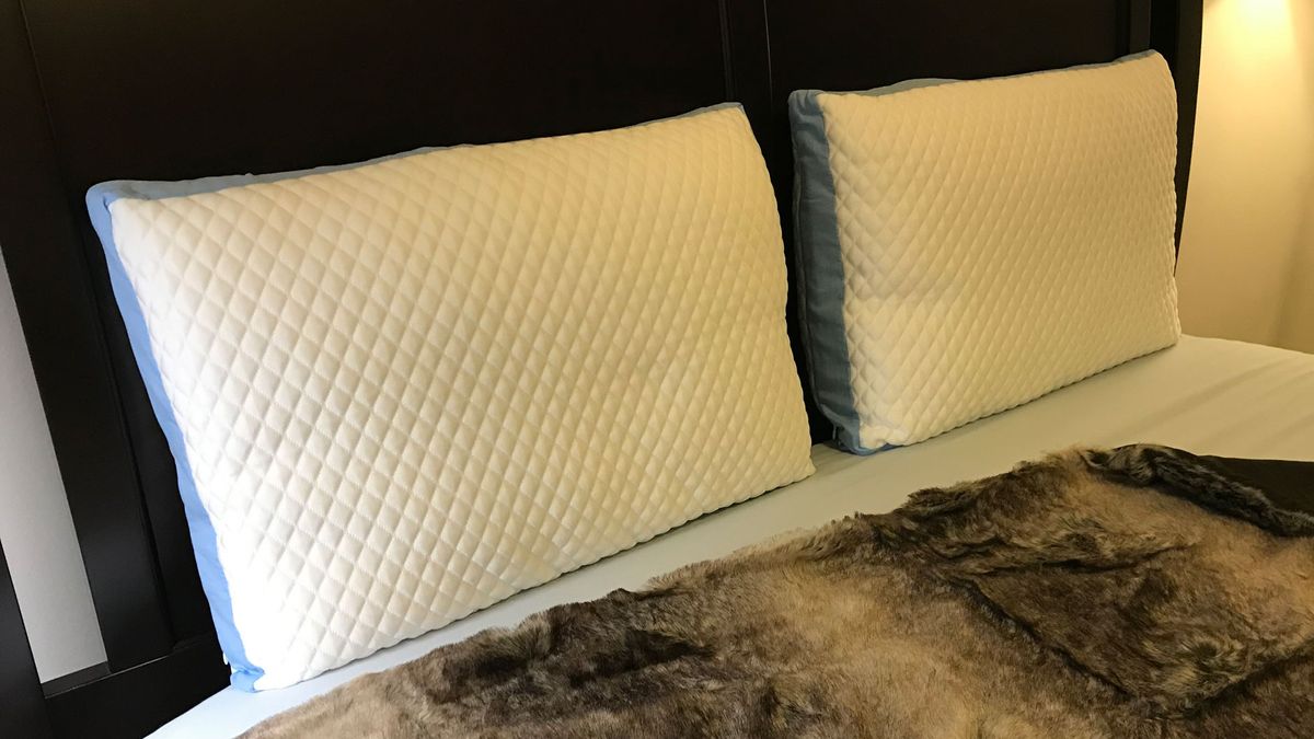 Two Pluto Pillows on a bed