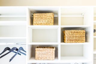 A closet with baskets and bins