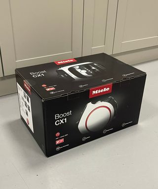 Miele Boost CX1 canister vacuum original packaging on concrete floor in Future test center