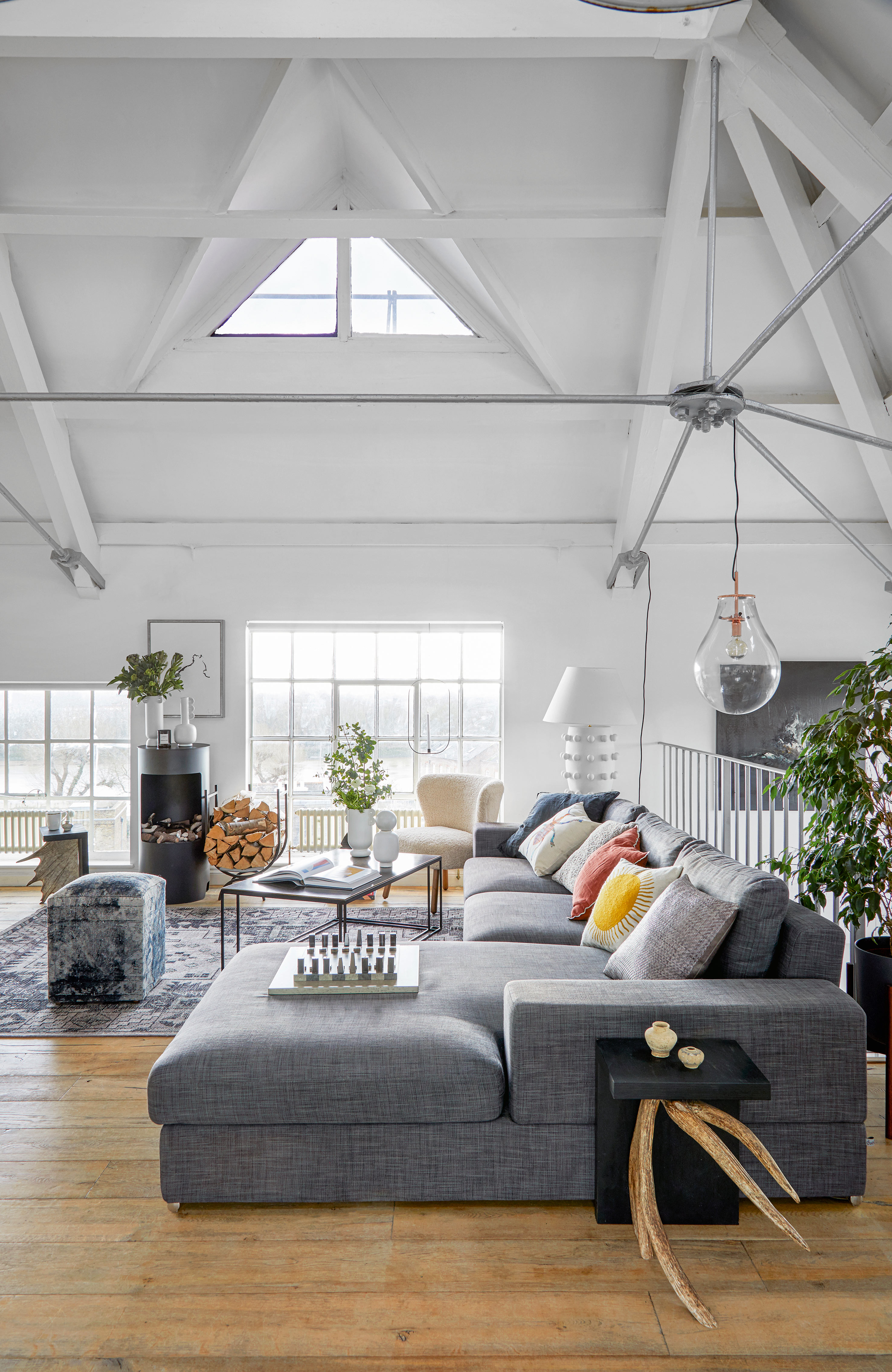 White studio apartment with larger grey corner sofa