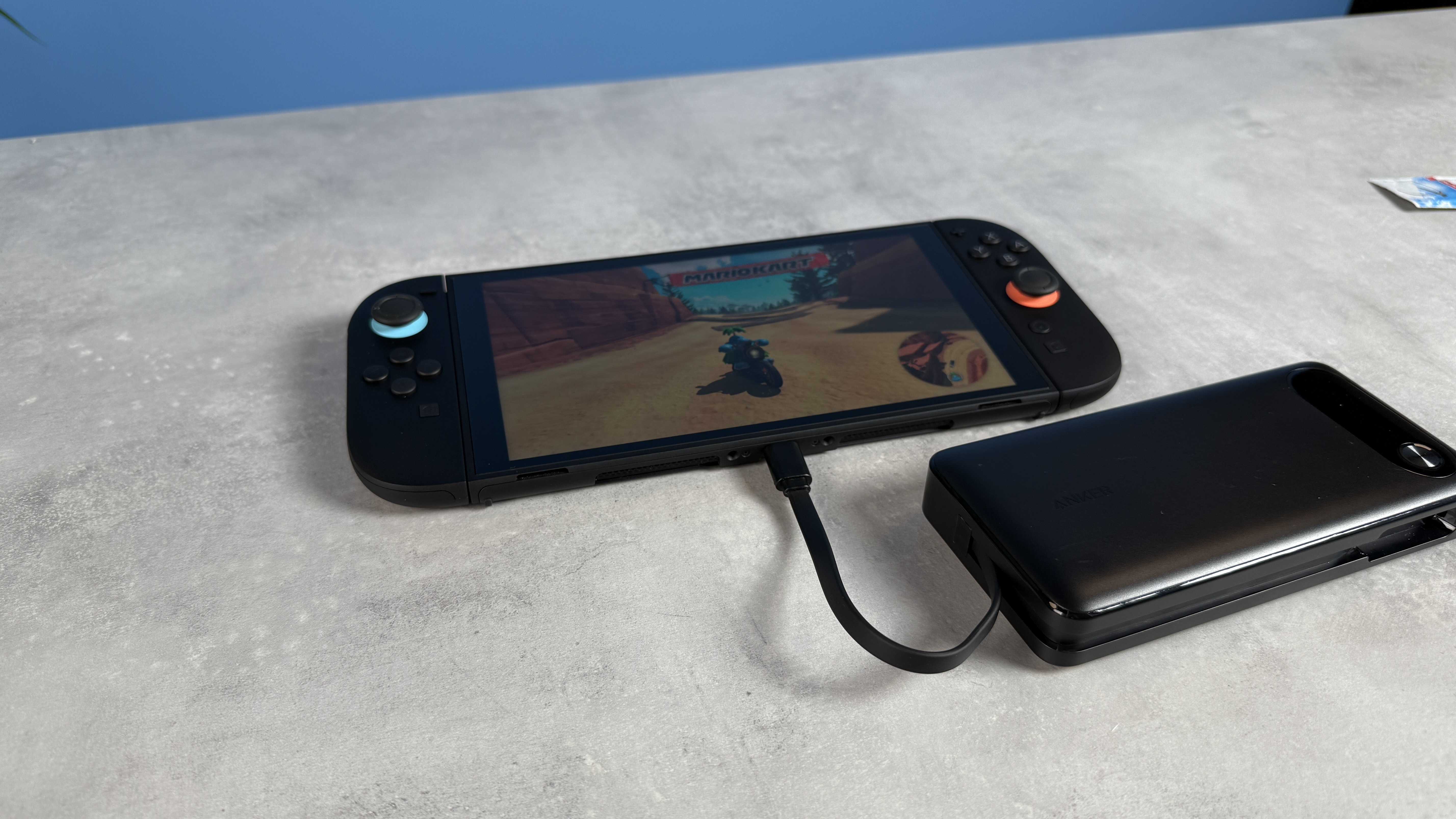 Anker 20,000mAh 87W power bank plugged into the Nintendo Switch 2 with Mario Kart World on-screen