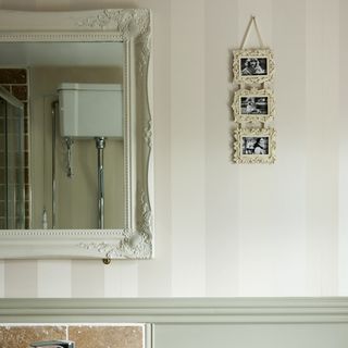 bathroom with french style mirror and white wall