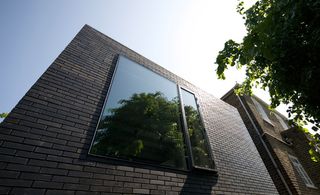 Building it inside out in slim-format Dutch engineering brick, a robust material with a delicate black glaze, the architects met the tight budget by using only simple primary materials, led by practical demands