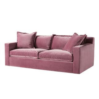 A velvet sleeper sofa in pink