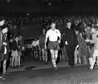 Tom Finney leads out his team at his testimonial match in 1960.