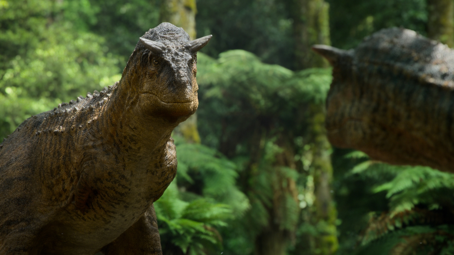 A Carnotaurus in forest shown in “Prehistoric Planet.”