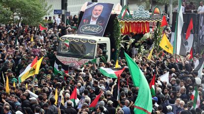 Iranians take part in a funeral procession for late Hamas leader Ismail Haniyeh, in Tehran, ahead of his burial in Qatar