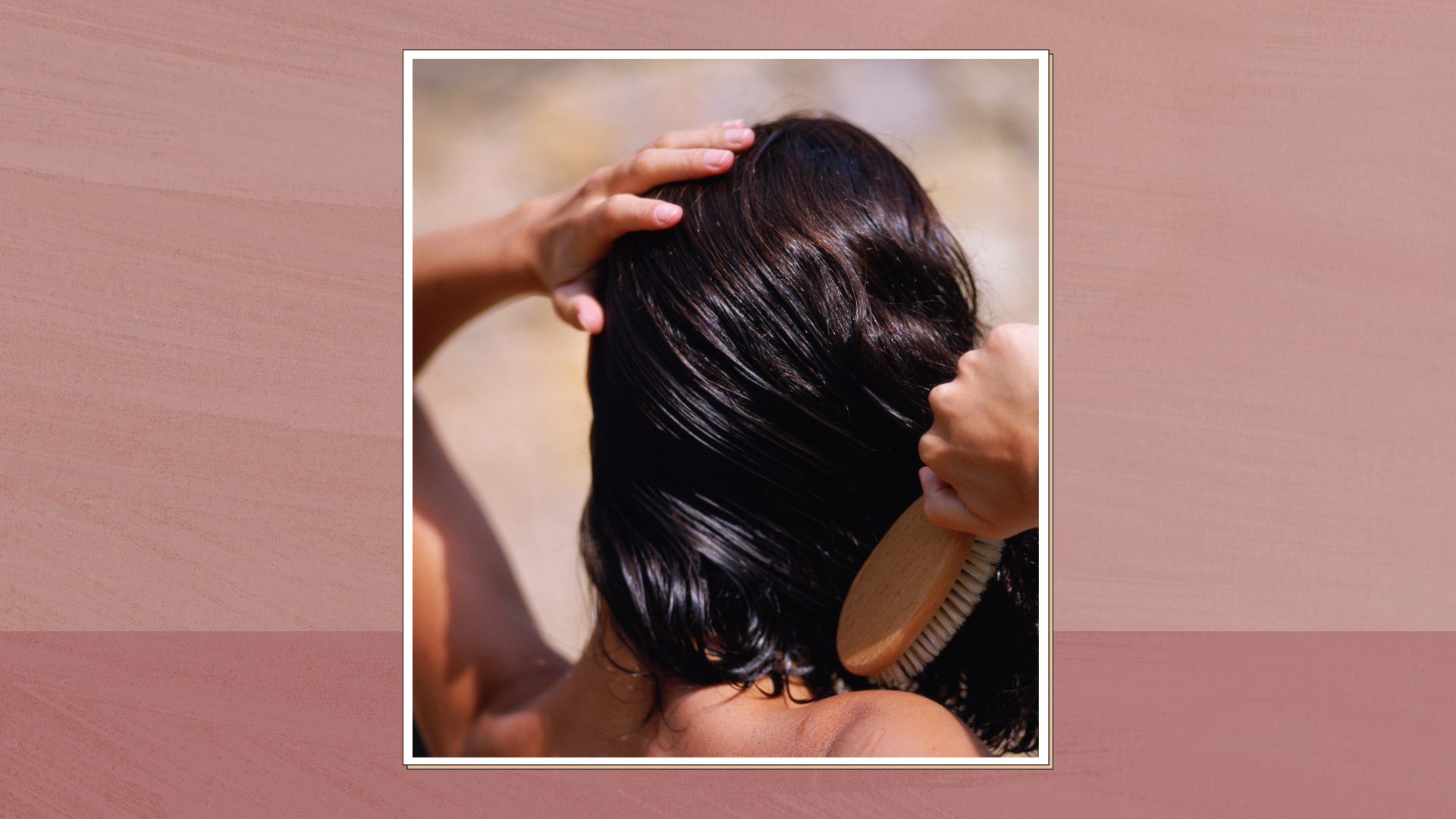 Image of the back of a woman's head while she brushes her hair, in a white frame against a dusky and dark pink two-tone background