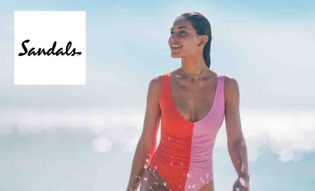 Sandals logo top left with a woman in a half red half pink swimsuit at the beach