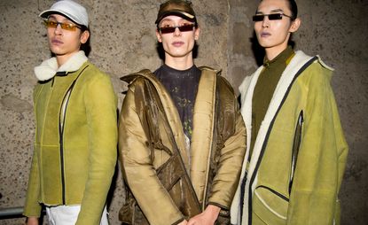 Three Asian male models wearing clothing by Cottweiler in shades of brown.