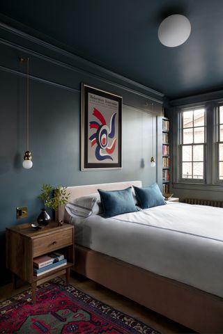 dark bedroom ideas with wall painted in Inchyra Blue by Farrow and Ball
