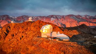 A photo of the Vera C Rubin observatory at sunset