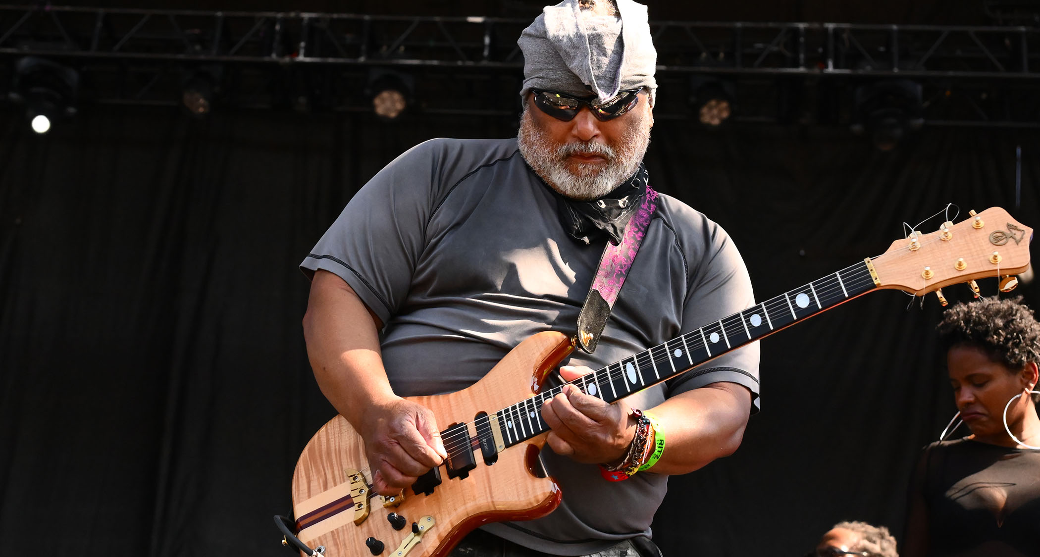 Michael “Kidd Funkadelic” plays his Alembic electric guitar onstage during Chicago's Riot Fest, 2003. He wears shades and a grey t-shirt