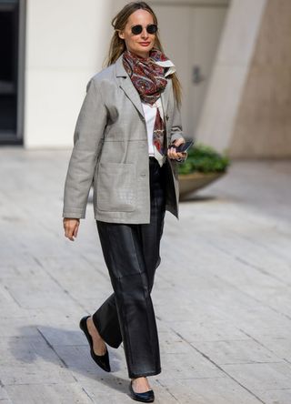 A guest wears grey leather jacket, black leather pants outside Toteme during New York Fashion Week on September 10, 2024 in New York City