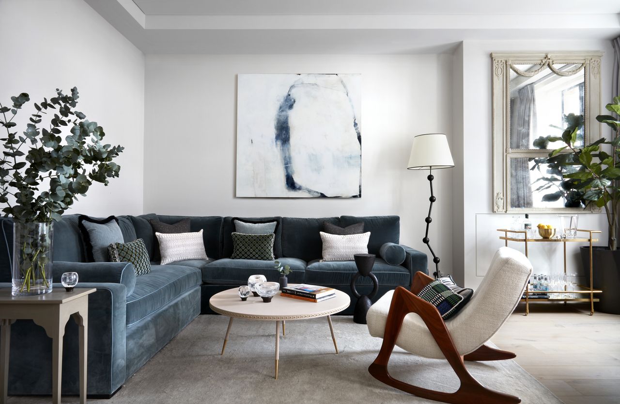 A living room with blue and grey furnishings