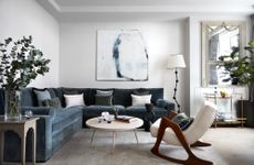 A living room with blue and grey furnishings